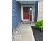 Inviting entryway with a red front door, welcome sign, and decorative wreath at 1287 Northcraft Ct, Franklin, IN 46131
