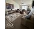 Cozy living room featuring carpet, comfortable seating, and a large area rug at 1287 Northcraft Ct, Franklin, IN 46131