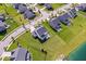 Aerial shot of a home in a lovely neighborhood with a pond, green lawns, and mature trees at 13410 Mancroft Dr, Fishers, IN 46037