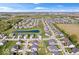 Aerial view of a suburban neighborhood featuring mature trees, a serene pond, and well-maintained homes at 13410 Mancroft Dr, Fishers, IN 46037