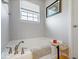 Relaxing bathroom showcasing a soaking tub with elegant fixtures at 13410 Mancroft Dr, Fishers, IN 46037