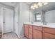 Bathroom featuring a double sink vanity, a large mirror, and good lighting at 13410 Mancroft Dr, Fishers, IN 46037