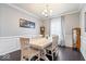 Elegant dining room with hardwood floors, wainscoting, and a classic chandelier at 13410 Mancroft Dr, Fishers, IN 46037