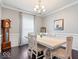 Formal dining room with chandelier, large windows, and classic furnishings at 13410 Mancroft Dr, Fishers, IN 46037