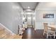 Inviting home entryway featuring hardwood floors, neutral paint, bench seating, and staircase at 13410 Mancroft Dr, Fishers, IN 46037