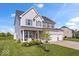 Beautiful two-story home with gray siding, a three-car garage, and a lush green lawn at 13410 Mancroft Dr, Fishers, IN 46037