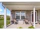 Relaxing front porch featuring stone accents, comfortable seating, and a welcoming entrance at 13410 Mancroft Dr, Fishers, IN 46037
