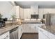 Modern kitchen with granite countertops, stainless steel appliances, and a breakfast bar at 13410 Mancroft Dr, Fishers, IN 46037