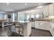 Open-concept kitchen with breakfast bar, stainless steel appliances, and easy access to the living area at 13410 Mancroft Dr, Fishers, IN 46037
