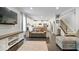 Spacious living room with dark wood floors, neutral paint, and an open layout leading to the kitchen at 13410 Mancroft Dr, Fishers, IN 46037