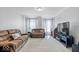 Cozy living room with plush sofas, a large TV, and soft carpeting at 13410 Mancroft Dr, Fishers, IN 46037