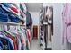 A very organized walk-in closet with built in shelving and clothing racks to maximize storage in a home at 13410 Mancroft Dr, Fishers, IN 46037
