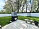 Landscaped backyard features a shed, grill, garden bench, and black flower pot with a white privacy fence at 135 Crestwood Ave, Crawfordsville, IN 47933