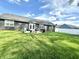 This backyard has a lush lawn, a patio area with seating, and a charcoal grill for outdoor entertaining at 135 Crestwood Ave, Crawfordsville, IN 47933