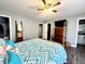 Spacious bedroom with a four-poster bed, a walk-in closet, and a dark wood dresser, offering ample storage at 135 Crestwood Ave, Crawfordsville, IN 47933