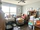This living room is filled with furniture, boxes, and decor, and has a large window to let in natural light at 135 Crestwood Ave, Crawfordsville, IN 47933