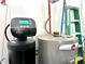This water system includes a water softener and water heater with visible pipes and connections at 135 Crestwood Ave, Crawfordsville, IN 47933