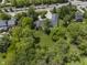Nestled among mature trees, this elegant home offers a private, tranquil escape with a circular driveway at 13909 Springmill Rd, Carmel, IN 46032
