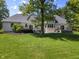 Backyard with a lush lawn, mature trees, and multiple decks accessible from the house at 13909 Springmill Rd, Carmel, IN 46032