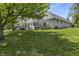 The house's back exterior is visible from an angle over a lush green lawn and several decks at 13909 Springmill Rd, Carmel, IN 46032