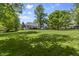 Expansive backyard features mature trees and a well-maintained lawn, offering ample space for outdoor activities and entertaining at 13909 Springmill Rd, Carmel, IN 46032