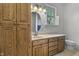 Bathroom featuring wood cabinets, a granite countertop, and a picturesque window at 13909 Springmill Rd, Carmel, IN 46032