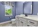 A quaint bathroom features a toilet, single vanity with mirror, and a sunlit window at 13909 Springmill Rd, Carmel, IN 46032