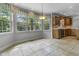 Bright breakfast nook with bay windows overlooking the greenery and tile flooring at 13909 Springmill Rd, Carmel, IN 46032
