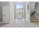 Bright foyer featuring tile floors, a staircase, and a front door with stained glass at 13909 Springmill Rd, Carmel, IN 46032