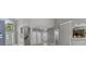 Foyer featuring a staircase, coat closet, arched window, and an opening to the kitchen at 13909 Springmill Rd, Carmel, IN 46032