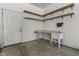 Functional garage corner features a utility sink, workspace, and ample shelving for organization and convenience at 13909 Springmill Rd, Carmel, IN 46032