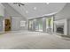 Expansive living area with fireplace, open layout, and sliding glass doors to the outdoor space at 13909 Springmill Rd, Carmel, IN 46032