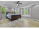 Spacious main bedroom boasts recessed lighting, tray ceiling, and large windows at 13909 Springmill Rd, Carmel, IN 46032