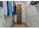 A walk-in closet boasts ample storage with built-in shelves and a cabinet, providing organized space at 13909 Springmill Rd, Carmel, IN 46032