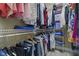 Organized walk-in closet with hanging clothes and shelving units at 13909 Springmill Rd, Carmel, IN 46032
