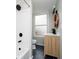 Bathroom featuring modern fixtures, a wood vanity, and a shower-tub combo at 1402 Olive St, Indianapolis, IN 46203