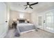 Bedroom features a ceiling fan, neutral décor, and French doors providing ample natural light at 1402 Olive St, Indianapolis, IN 46203