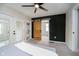 Bedroom with French doors, wooden sliding door, and an accent wall at 1402 Olive St, Indianapolis, IN 46203