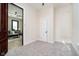Cozy bedroom with neutral carpet, door, and a glimpse into a connected living space at 1402 Olive St, Indianapolis, IN 46203