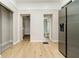 Hallway leads to doorways and a glimpse of the bathroom with a stainless steel refrigerator nearby at 1402 Olive St, Indianapolis, IN 46203