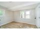 Light-filled room features modern vinyl flooring, and neutral paint at 1402 Olive St, Indianapolis, IN 46203