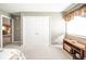 Bedroom showcasing a closet, view to the kitchen, neutral walls and wood accent table at 143 Asbury Dr # 86A, Anderson, IN 46013