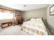 Comfortable bedroom with floral bedding, a wooden desk and a bookshelf at 143 Asbury Dr # 86A, Anderson, IN 46013