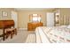 Bright bedroom with a bed, wooden desk, and tri-fold mirror on wooden dresser at 143 Asbury Dr # 86A, Anderson, IN 46013