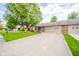 Spacious home featuring a large driveway and well-kept lawn with mature trees at 143 Asbury Dr # 86A, Anderson, IN 46013