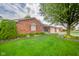Charming single-story brick home with tidy front lawn and inviting curb appeal at 143 Asbury Dr # 86A, Anderson, IN 46013