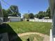Spacious backyard featuring a well-kept lawn and a detached garage at 144 Bel Aire Dr, Whiteland, IN 46184