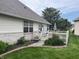 Beautiful backyard featuring a patio area with a white picket fence and lush landscaping at 1604 Stonewall Dr, Greenfield, IN 46140