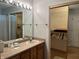 Bathroom with wooden cabinets, large mirror, and large closet at 1604 Stonewall Dr, Greenfield, IN 46140