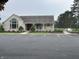 Community clubhouse with ample parking, well-maintained landscaping, and accessibility ramps at 1604 Stonewall Dr, Greenfield, IN 46140